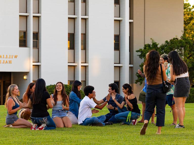 First-year students on grass outside of Williams Hall.